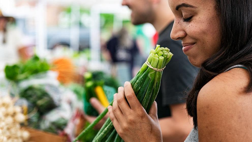Eine Frau beim Gemüse am Markt